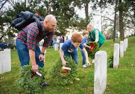 family-places-wreaths-on-headstones-in-arlington-na_crop