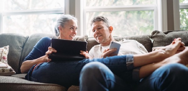 Mature Couple Relaxing with Tablet and Smartphone